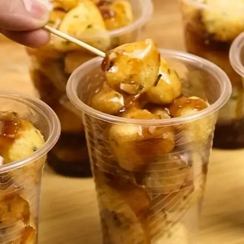 street-style veggie balls serve in plastic cups with savory Manong sauce