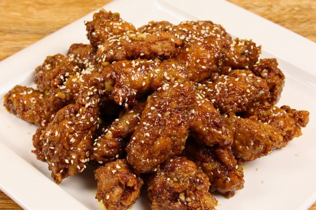 Crispy garlic butter chicken wings glazed with sweet-savory sauce on a plate
