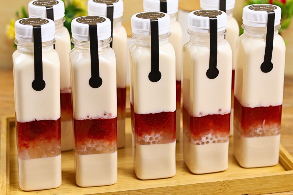 Strawberry Jelly Milk Drink in a square PET bottle with layers of jelly, tapioca pearls, strawberry jam, and creamy milk