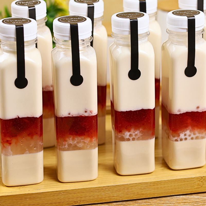 Strawberry Jelly Milk Drink in a square PET bottle with layers of jelly, tapioca pearls, strawberry jam, and creamy milk