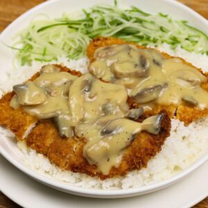 Crispy chicken cutlet served with creamy mushroom sauce