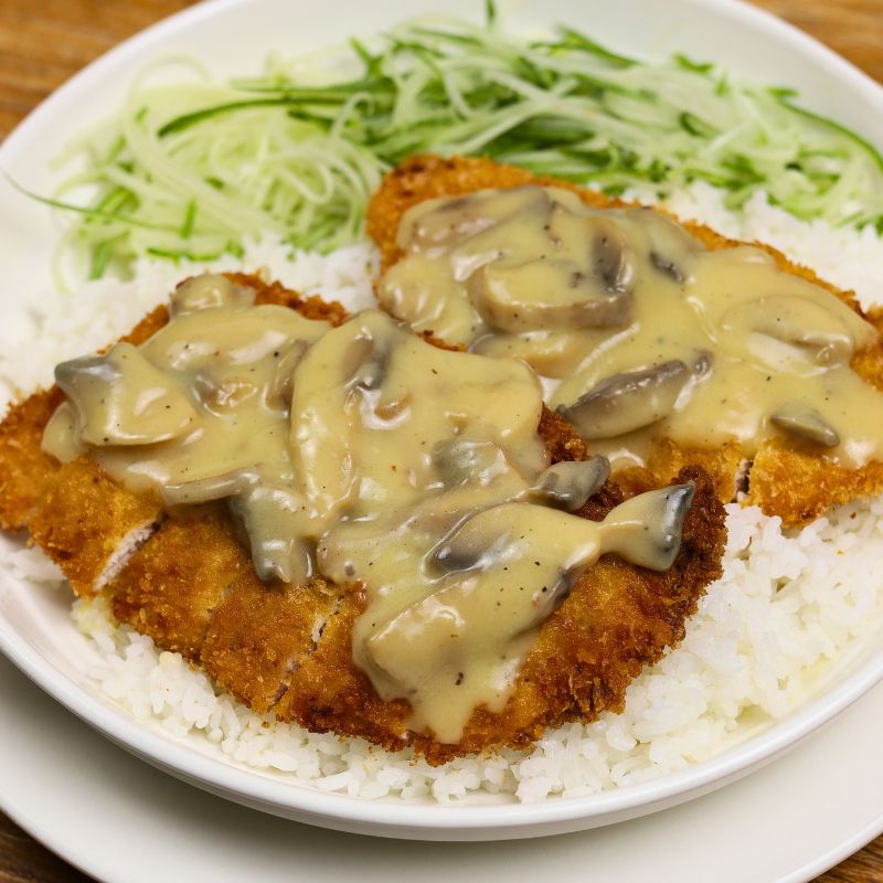 Crispy chicken cutlet served with creamy mushroom sauce