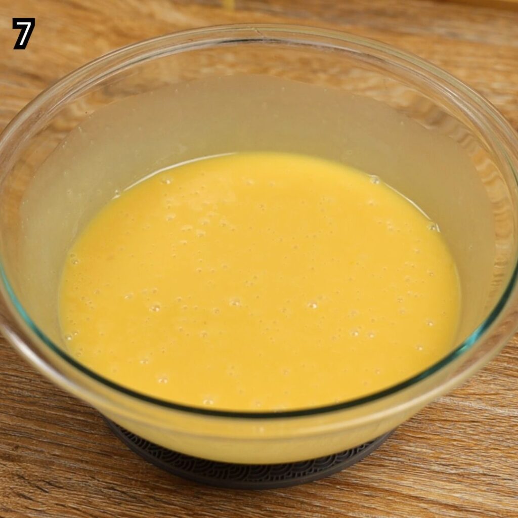 Mixing the wet ingredients until smooth and well combined for Condensed Milk Cake Bars.