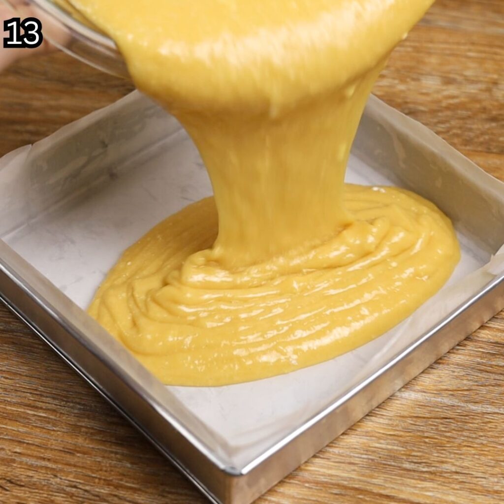 Pouring the Condensed Milk Cake Bars batter into a prepared 8×8-inch baking pan.