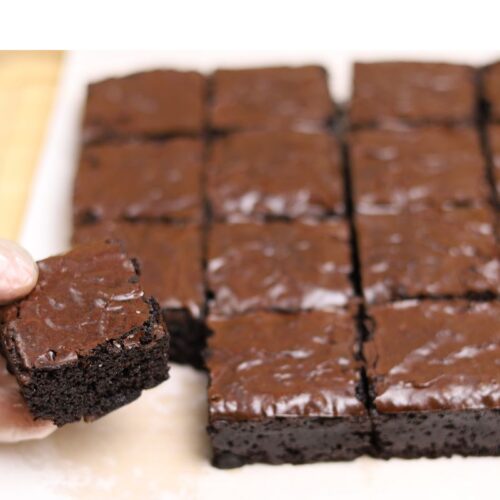 Fudgy brownies with a shiny crinkle top and rich chocolate texture sliced into squares