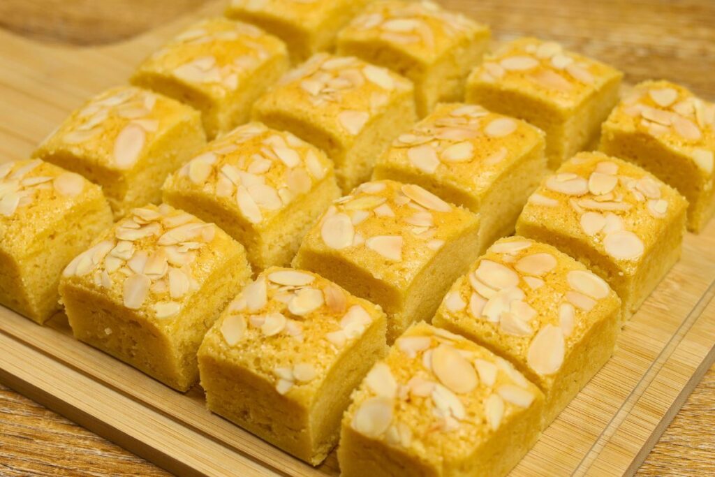 Condensed Milk Cake Bars cut into squares with a soft, moist crumb