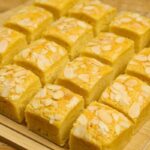 Condensed Milk Cake Bars cut into squares with a soft, moist crumb