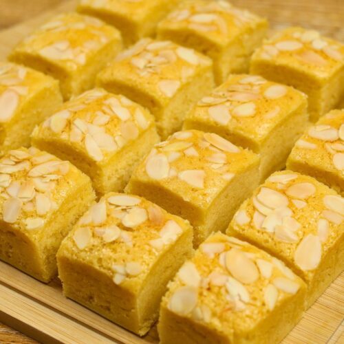 Condensed Milk Cake Bars cut into squares with a soft, moist crumb