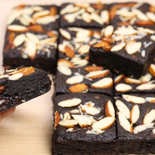 Hand holding a rich, fudgy Eggless Almond Brownie