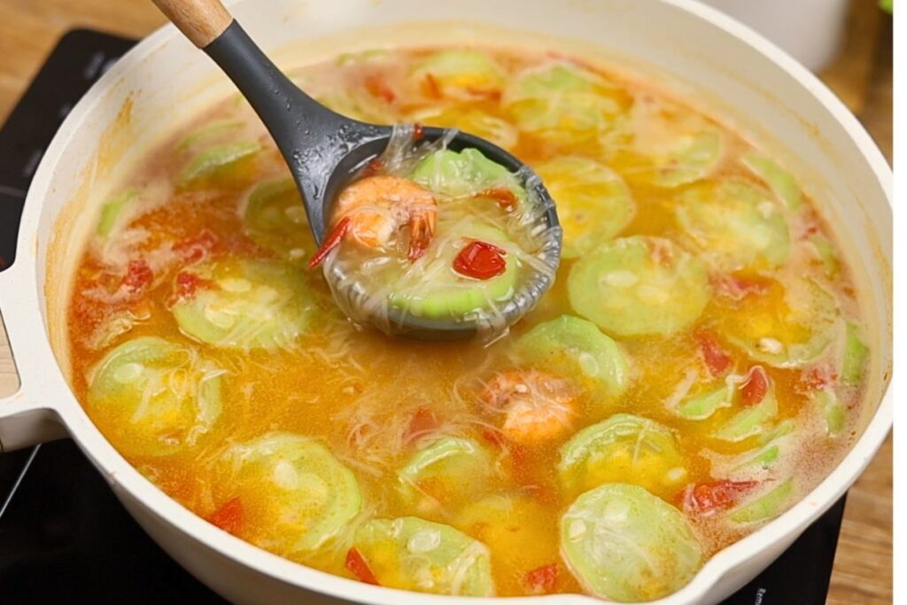 Cooked Misua with Patola and Shrimp in a pan with tender shrimp, patola, and misua noodles in a light broth.