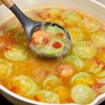 Cooked Misua with Patola and Shrimp in a pan with tender shrimp, patola, and misua noodles in a light broth.