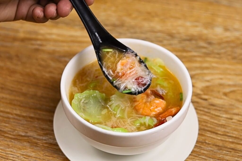 A single serving of Misua with Patola and Shrimp in a bowl, featuring tender shrimp, soft patola, and delicate misua noodles in a light, flavorful broth.