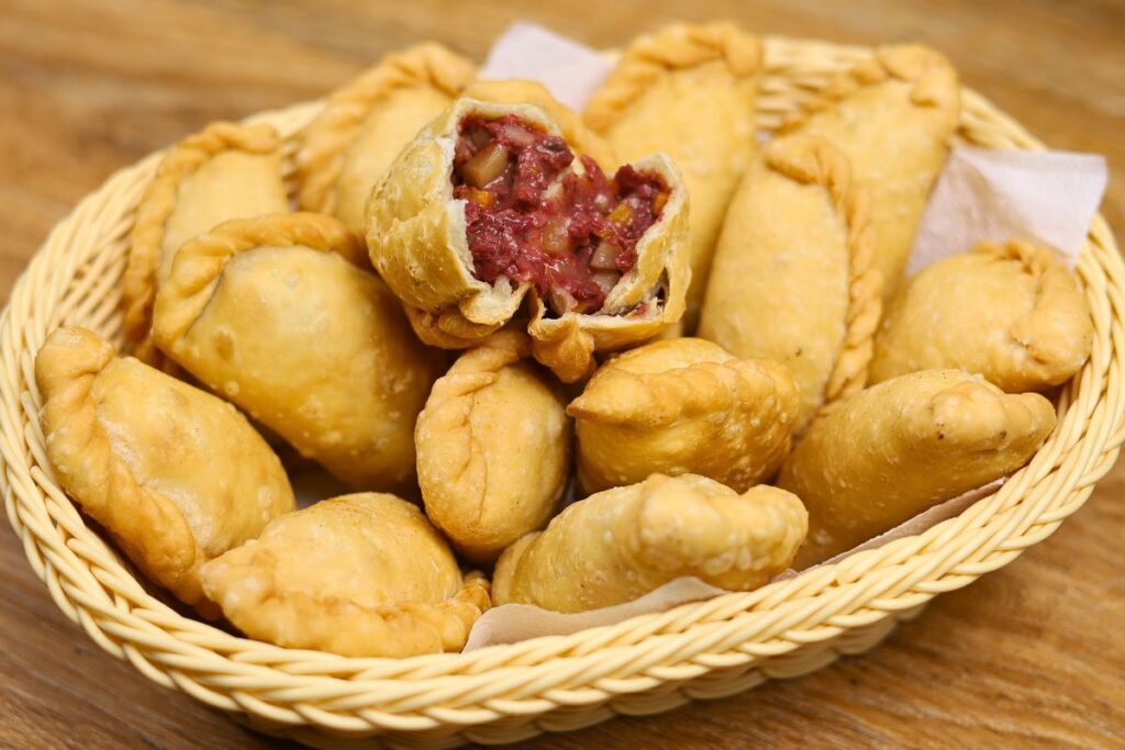 Corned beef empanada with crispy golden crust and savory filling of corned beef, potatoes, and carrots